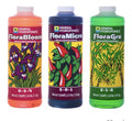 Three bottles of General Hydroponics Flora series on a white background