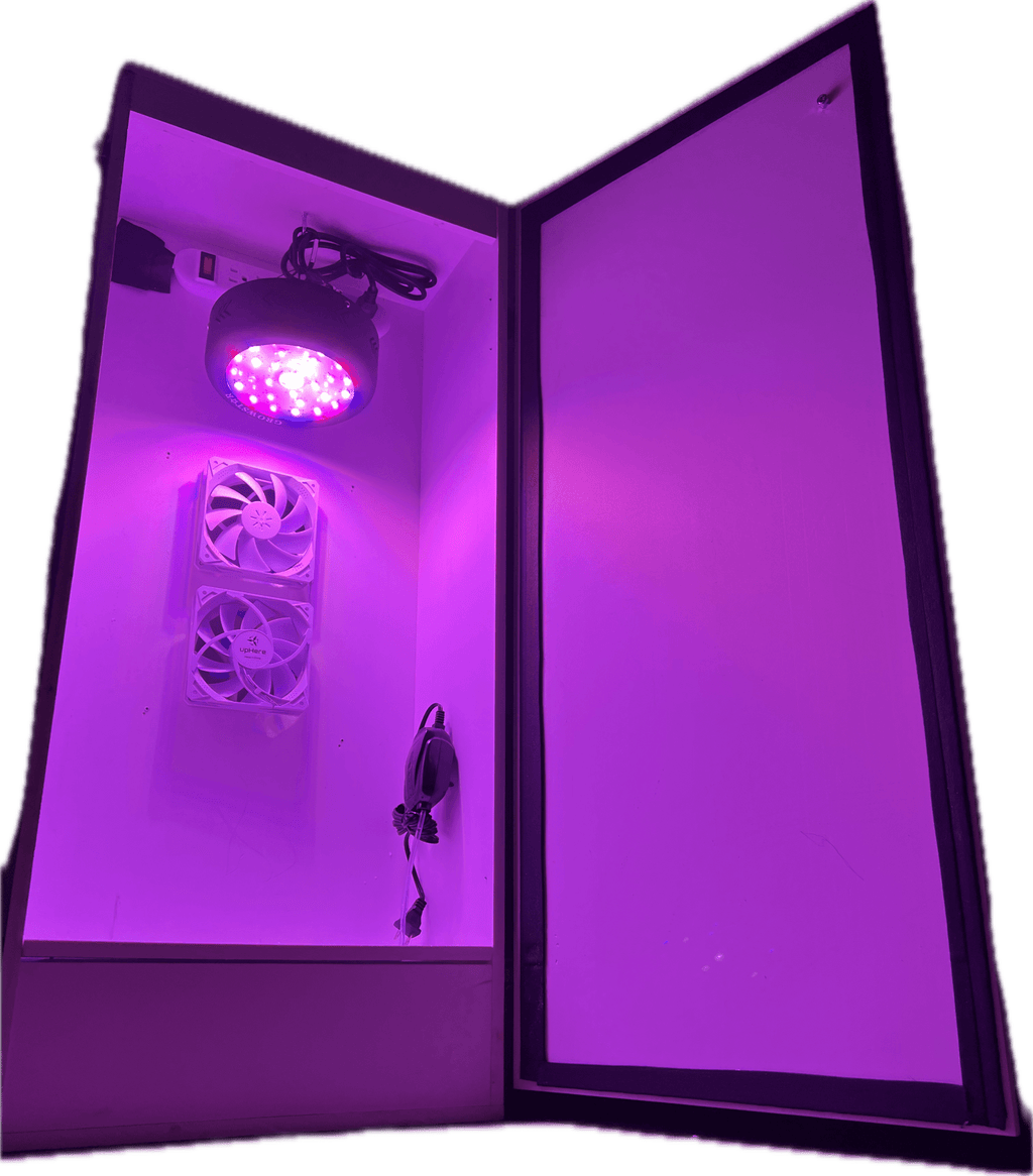 Purple LED grow light with fans inside a grow box on a white background